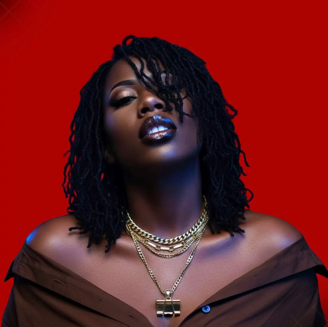Jade Massentoff - dramatic portrait with red background and gold chains